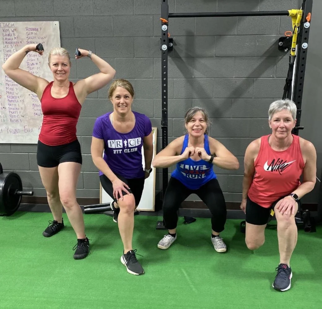 Four women pose for a photograph during a fitness class