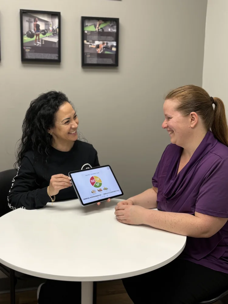 Female trainer conducts nutrition consultation with woman