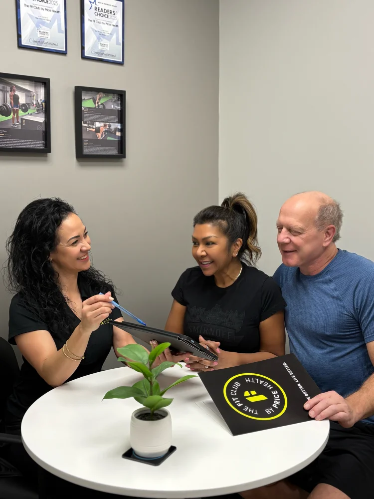 Female trainer conducts nutrition consultation with woman and man